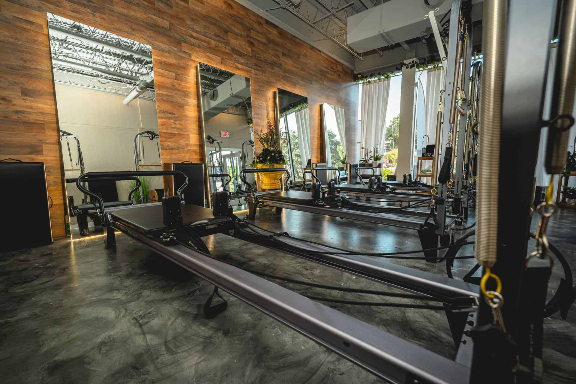 Pilates for beginners Houston: coach guiding a new client on the reformer at Sigma